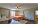 Cozy bedroom featuring hardwood floors, natural light and access to an ensuite bathroom at 145 S Peninsula Dr, Daytona Beach, FL 32118