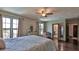 Sunny bedroom features natural light, wood floors and an ensuite bathroom at 145 S Peninsula Dr, Daytona Beach, FL 32118