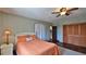 Comfortable bedroom with a ceiling fan, hardwood floors and closet with paneled doors at 145 S Peninsula Dr, Daytona Beach, FL 32118