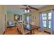 Bright dining room with hardwood floors, a modern ceiling fan, and access to the pool at 145 S Peninsula Dr, Daytona Beach, FL 32118