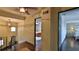 Inviting hallway with wood floors leads to bedrooms and a staircase with decorative lighting at 145 S Peninsula Dr, Daytona Beach, FL 32118
