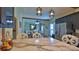 Bright eat-in kitchen features a marble countertop, stainless steel appliances, and pendant lighting at 145 S Peninsula Dr, Daytona Beach, FL 32118