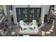 Inviting outdoor seating area with light blue chairs and a stylish rug, perfect for relaxing near the home's dark-framed doors at 145 S Peninsula Dr, Daytona Beach, FL 32118