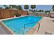 Backyard pool features crystal clear blue water and a well maintained area, enclosed with a wood fence at 145 S Peninsula Dr, Daytona Beach, FL 32118