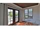 Inviting sunroom with tiled floor, leading to the backyard through French doors at 145 S Peninsula Dr, Daytona Beach, FL 32118