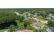 Aerial view showcases a private pool, proximity to a scenic pond, and verdant surroundings, enhancing the property's appeal at 1491 Nappa Dr, Port Orange, FL 32128