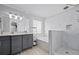 Bright bathroom featuring double sinks, gray cabinets, and marble tile at 1491 Nappa Dr, Port Orange, FL 32128