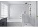 Bright bathroom featuring white marble tile, bathtub, and a glass shower at 1491 Nappa Dr, Port Orange, FL 32128