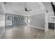 Spacious bedroom showcasing wood-look accent wall, tray ceiling, and light gray flooring at 1491 Nappa Dr, Port Orange, FL 32128