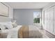 A beautifully furnished bedroom with cozy bedding, a window view, and a closet at 1491 Nappa Dr, Port Orange, FL 32128