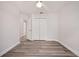Bright, empty bedroom with a window, a closet and wood-look floors. Great potential for personalization at 1491 Nappa Dr, Port Orange, FL 32128