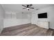 Bright bonus room featuring light wood-look floors, a ceiling fan, and a wall-mounted tv at 1491 Nappa Dr, Port Orange, FL 32128