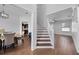 Elegant dining area featuring wood floors, staircase, and view of the kitchen at 1491 Nappa Dr, Port Orange, FL 32128