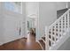 Inviting foyer with wood flooring, staircase, and a view into the adjacent dining room at 1491 Nappa Dr, Port Orange, FL 32128