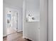 Bright hallway with light-colored walls and wood-look floors that lead to another room at 1491 Nappa Dr, Port Orange, FL 32128