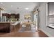 Dining area and kitchen featuring wood floors and island with breakfast bar at 1491 Nappa Dr, Port Orange, FL 32128