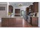 Beautiful kitchen with dark wood cabinets, granite countertops, stainless steel appliances, and wood-look tile flooring at 1491 Nappa Dr, Port Orange, FL 32128