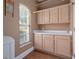 Practical laundry room featuring cabinets, counter space, window, and tile flooring at 1491 Nappa Dr, Port Orange, FL 32128