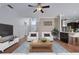 Cozy living room with ample seating, decorative wall accents, and an open layout with wood floors at 1491 Nappa Dr, Port Orange, FL 32128