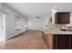 Open concept living room and kitchen featuring wood floors and light walls at 1491 Nappa Dr, Port Orange, FL 32128