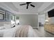 Comfortable main bedroom featuring a tray ceiling, ceiling fan, and ensuite bathroom at 1491 Nappa Dr, Port Orange, FL 32128