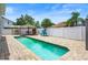 Backyard pool area complete with a tiki hut, grill, lounge chair, and privacy fence at 1491 Nappa Dr, Port Orange, FL 32128