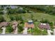 Aerial view of property near a lake featuring a private pool, lush landscaping, and a fenced backyard at 160 Point O Woods Dr, Daytona Beach, FL 32114