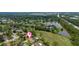 Picturesque aerial view highlighting homes by a lake, creating a peaceful living environment at 160 Point O Woods Dr, Daytona Beach, FL 32114