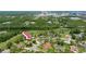 Neighborhood aerial view showcases lush landscaping and proximity to Daytona International Speedway at 160 Point O Woods Dr, Daytona Beach, FL 32114