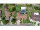 Aerial view of property with pool, lush landscaping, and privacy fence on a large, rectangular lot at 160 Point O Woods Dr, Daytona Beach, FL 32114