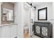 Bright bathroom featuring modern vanity, toilet room with sliding barn door, and blue mirrored cabinet at 160 Point O Woods Dr, Daytona Beach, FL 32114