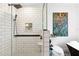 Modern bathroom featuring a glass-enclosed shower with stylish tile work and a colorful painting accenting the space at 160 Point O Woods Dr, Daytona Beach, FL 32114