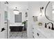 Modern bathroom featuring black soaking tub, vanity with white marble countertop, and patterned tile flooring at 160 Point O Woods Dr, Daytona Beach, FL 32114