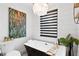 Elegant bathroom featuring a black and white tub, shiplap walls, and a contemporary chandelier at 160 Point O Woods Dr, Daytona Beach, FL 32114