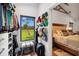 Walk-in closet with hats, clothing rods, a bench, and a view of the sunny green yard through the window at 160 Point O Woods Dr, Daytona Beach, FL 32114