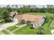 Beautiful home with a lush green lawn, manicured landscaping, and a paver driveway and walkway at 160 Point O Woods Dr, Daytona Beach, FL 32114