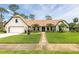 Charming home boasts a brick-paved driveway, inviting curb appeal, and well-maintained landscaping at 160 Point O Woods Dr, Daytona Beach, FL 32114