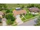 Aerial view of a beautiful home with lush landscaping, paver driveway, and a fenced backyard at 160 Point O Woods Dr, Daytona Beach, FL 32114