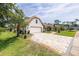 Charming home boasts a brick-paved driveway, inviting curb appeal, and well-maintained landscaping at 160 Point O Woods Dr, Daytona Beach, FL 32114