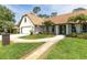 Charming home boasts a brick-paved driveway, inviting curb appeal, and well-maintained landscaping at 160 Point O Woods Dr, Daytona Beach, FL 32114