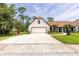 Charming home boasts a brick-paved driveway, inviting curb appeal, and well-maintained landscaping at 160 Point O Woods Dr, Daytona Beach, FL 32114