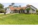 Beautiful home featuring a spacious lawn, manicured landscaping, and elegant exterior finishes at 160 Point O Woods Dr, Daytona Beach, FL 32114