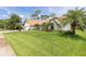 Beautiful home featuring a spacious lawn, manicured landscaping, and elegant exterior finishes at 160 Point O Woods Dr, Daytona Beach, FL 32114