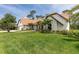 Beautiful home featuring a spacious lawn, manicured landscaping, and elegant exterior finishes at 160 Point O Woods Dr, Daytona Beach, FL 32114