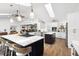 Open kitchen featuring a large island with seating, stainless steel appliances and abundant cabinet space at 160 Point O Woods Dr, Daytona Beach, FL 32114