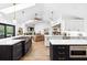 Well-lit kitchen with stainless appliances, double islands, and an open layout into the living room at 160 Point O Woods Dr, Daytona Beach, FL 32114