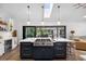Modern kitchen featuring a large island, skylight, and stainless steel appliances at 160 Point O Woods Dr, Daytona Beach, FL 32114