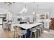 Bright kitchen featuring a large center island with seating, modern lighting, and stainless steel appliances at 160 Point O Woods Dr, Daytona Beach, FL 32114