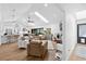 Bright living room with vaulted ceiling, skylights, and comfortable leather seating arrangement at 160 Point O Woods Dr, Daytona Beach, FL 32114