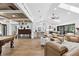 Open concept living area with vaulted ceilings, leather furniture, and a large kitchen island at 160 Point O Woods Dr, Daytona Beach, FL 32114